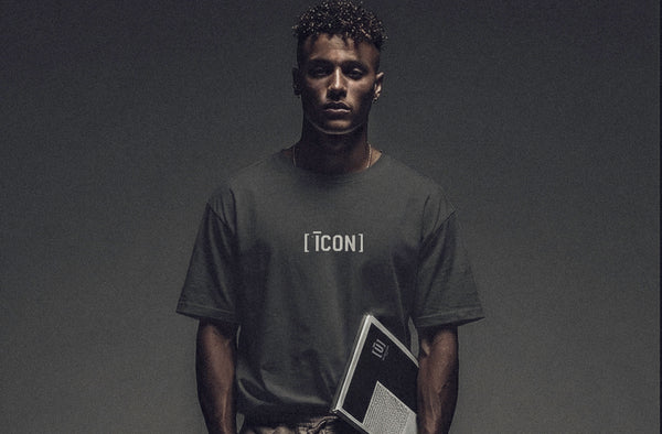 Model wearing ['ĪCON]™ t-shirt in muted tone, minimal studio lighting