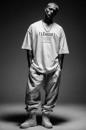 Person wearing a 'League' t-shirt in a black and white photo